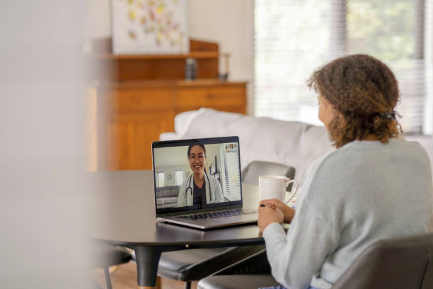 A female patent meets with her doctor remotely via a video call