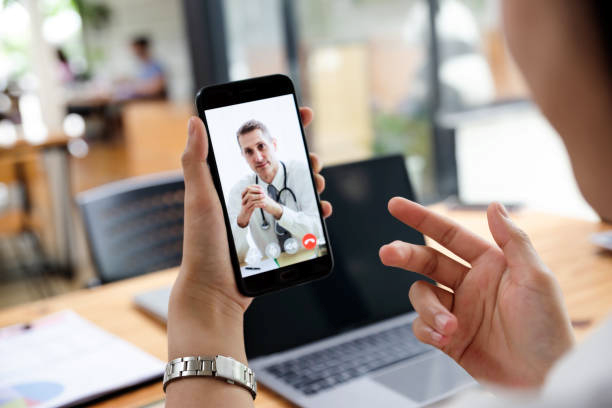 Medical specialist consulting patient on mobile phone